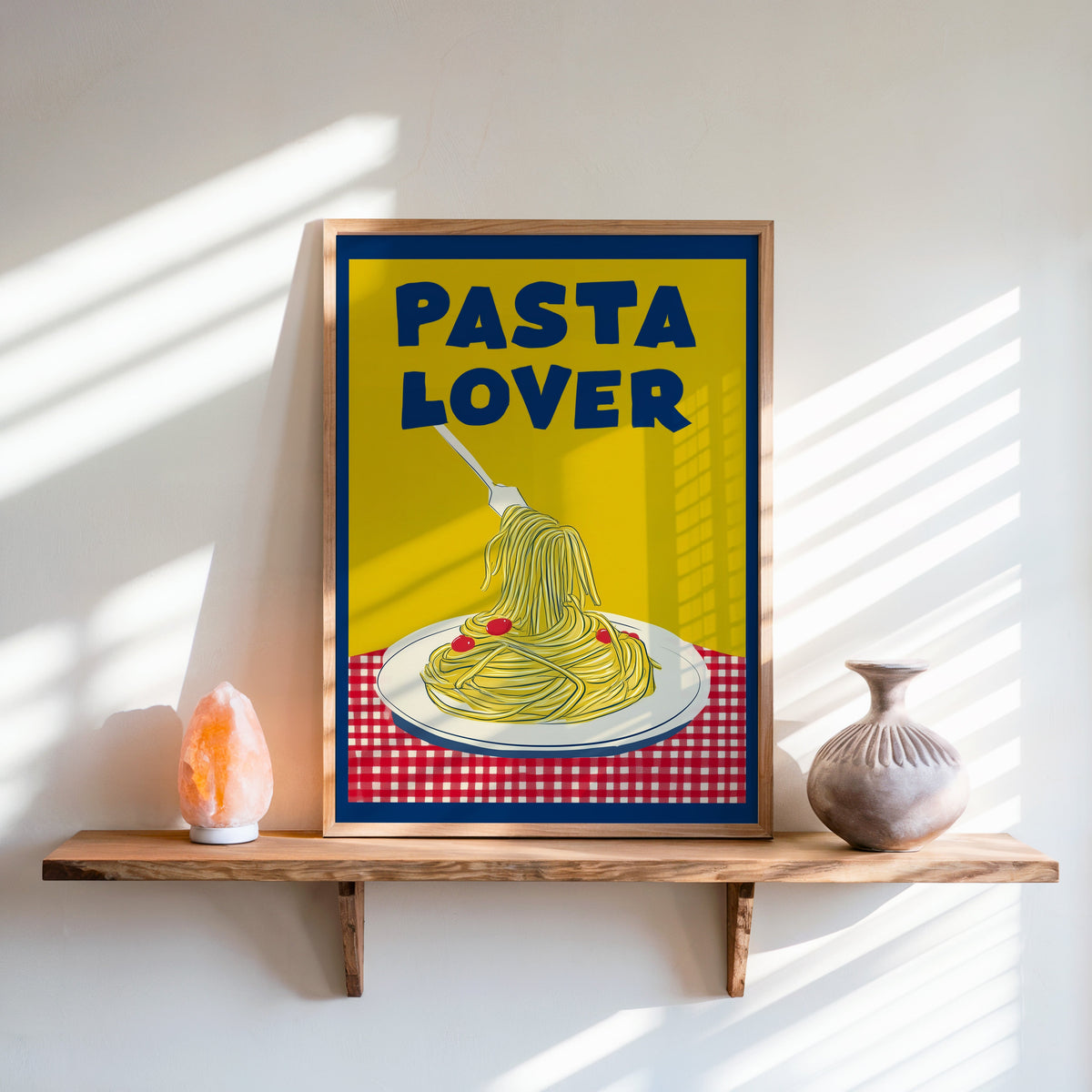 Pasta Lover yellow print in an oak frame on a live-edge shelf beside a salt lamp