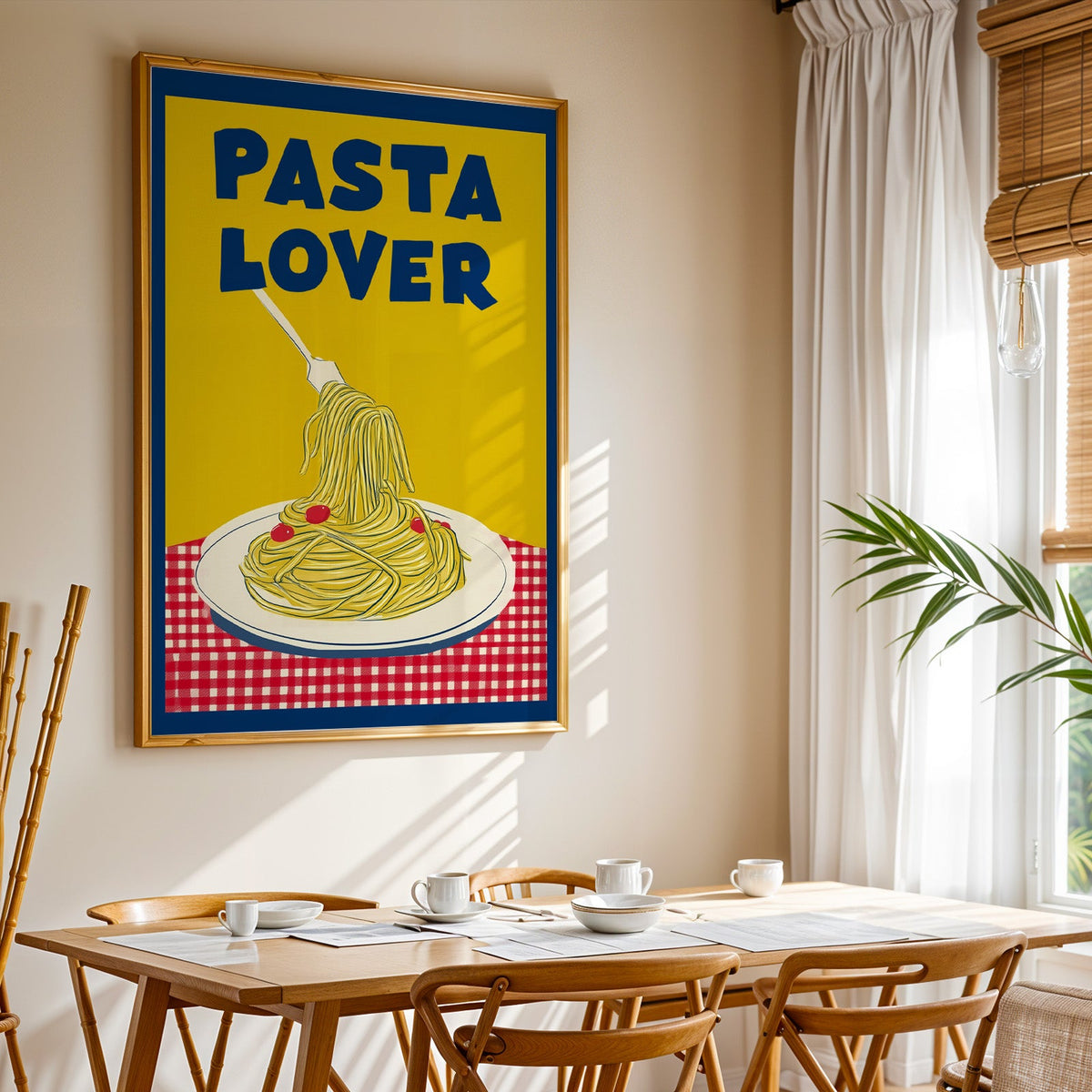Pasta Lover yellow print shown in a gold frame above a breakfast table by a curtained window