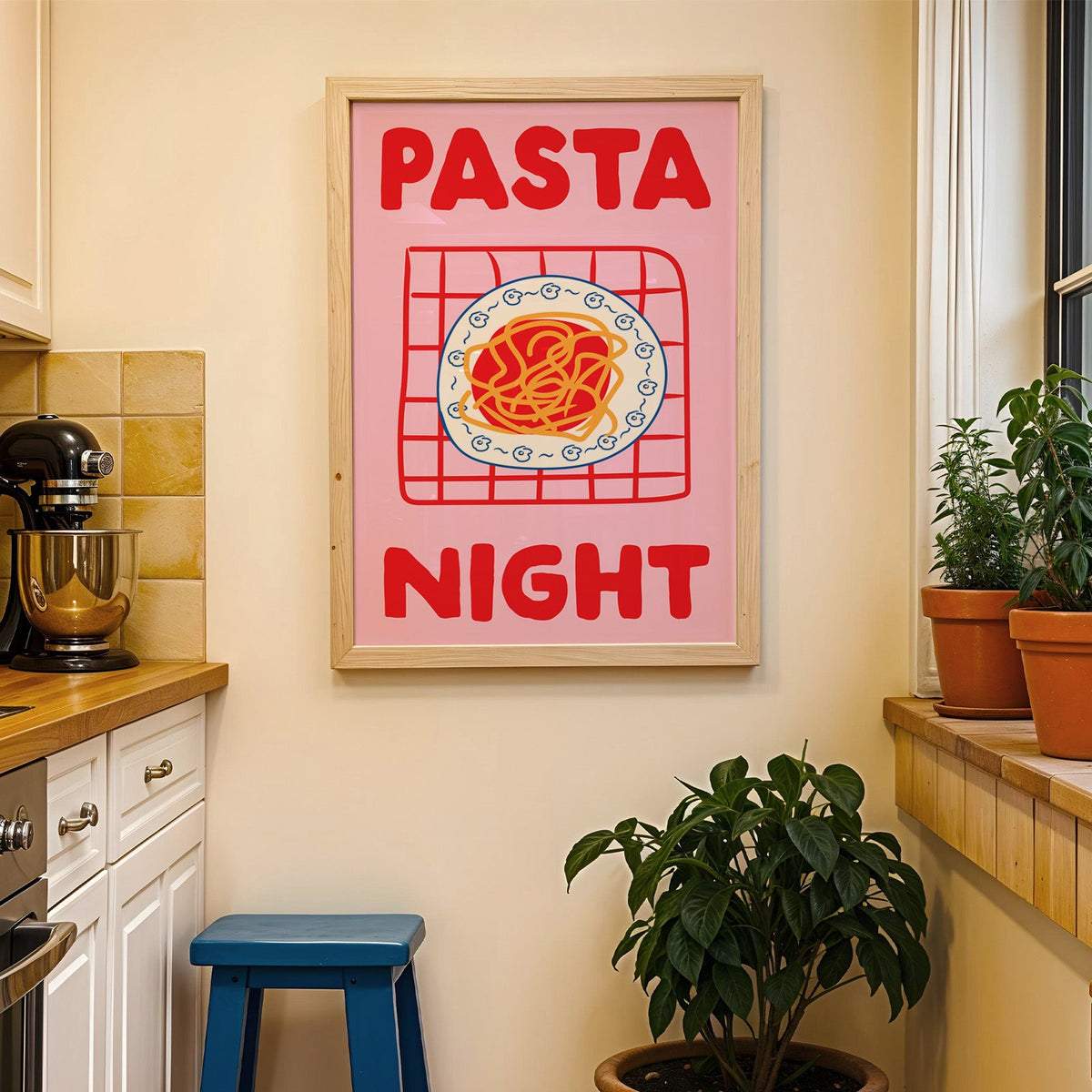 Pasta night pink print in a wood frame on a yellow tiled kitchen wall