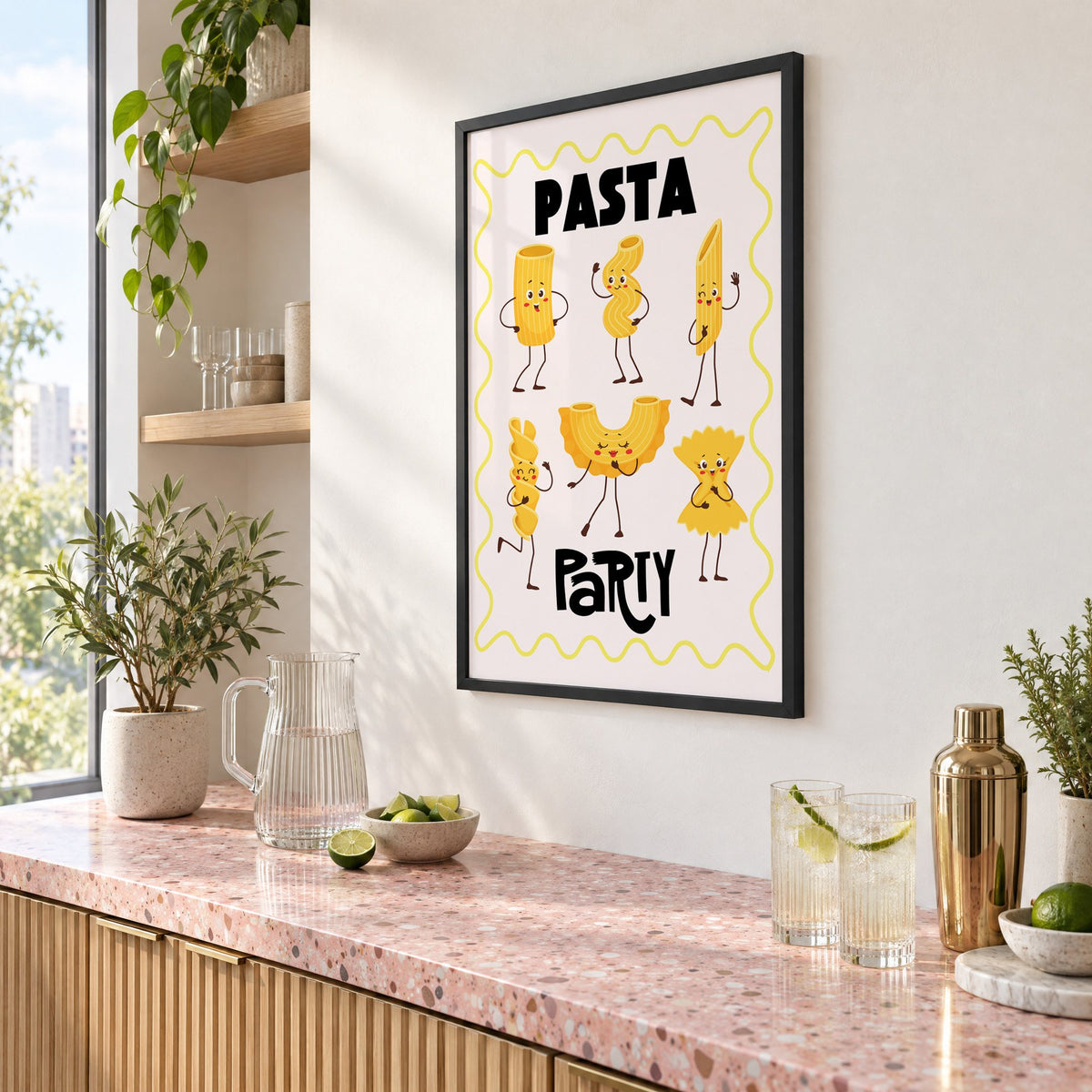 Pasta Party cartoon noodles print in a black frame above a pink terrazzo cocktail counter with limes, seen at an angle