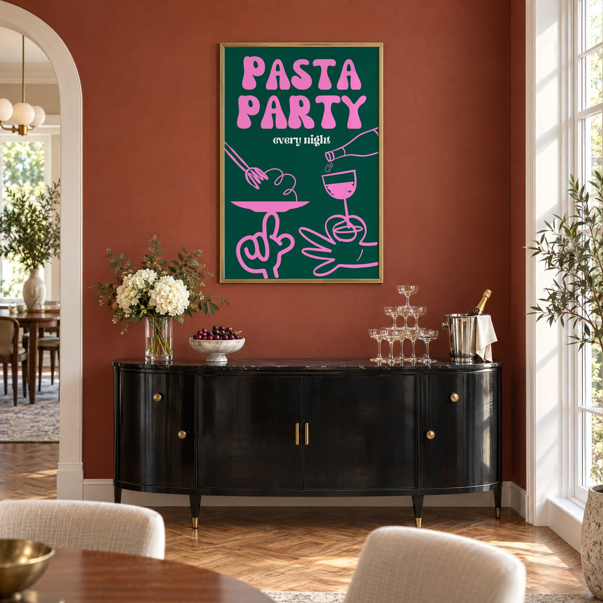 Pasta Party every night green print in a brass frame on a terracotta wall above a black buffet with a champagne tower