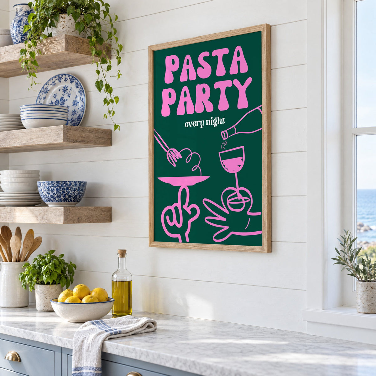 Pasta Party every night green print in an oak frame in a white coastal kitchen beside blue and white plates