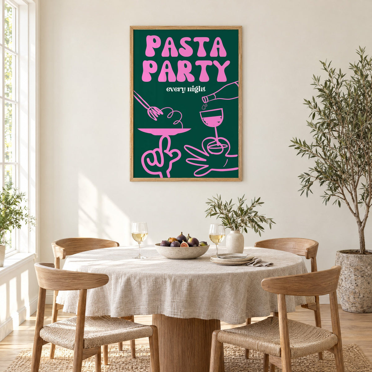 Pasta Party every night green print in an oak frame above a round linen-covered dining table with figs and wine