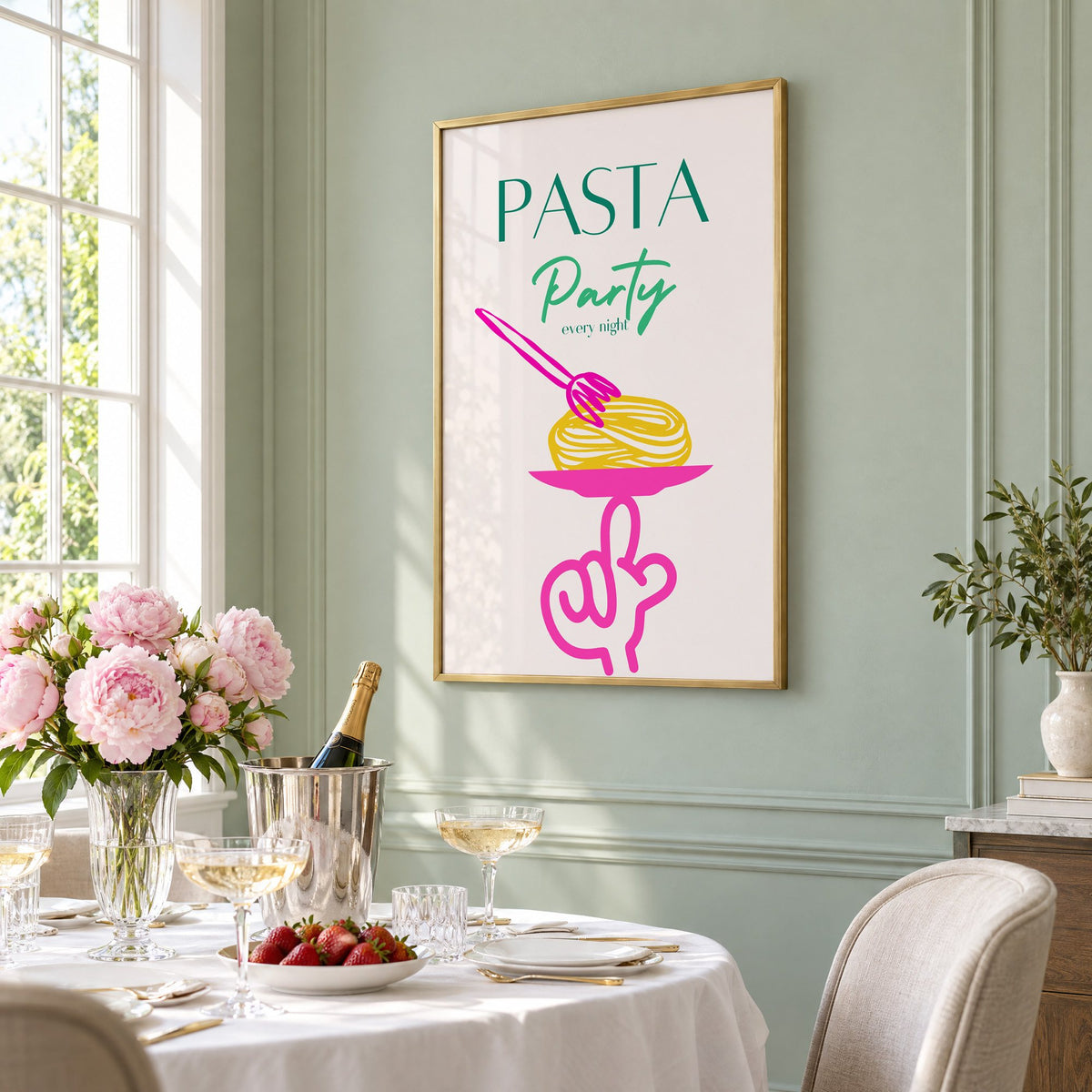 PASTA Party every night spaghetti plate print in a brass frame on a sage wall above a brunch table with champagne and peonies, seen at an angle