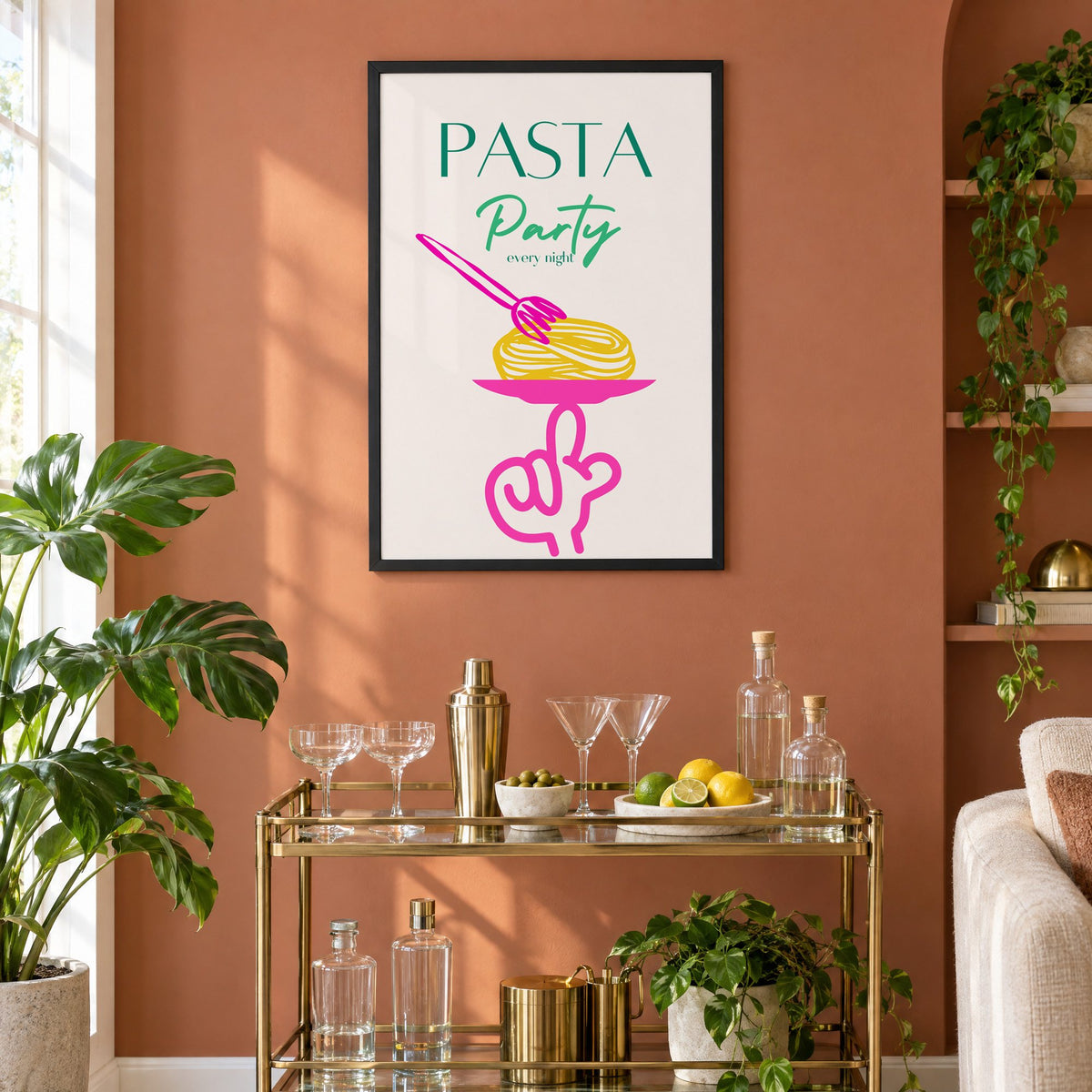 PASTA Party every night spaghetti plate print in a black frame on a terracotta wall above a brass bar cart with coupes and citrus