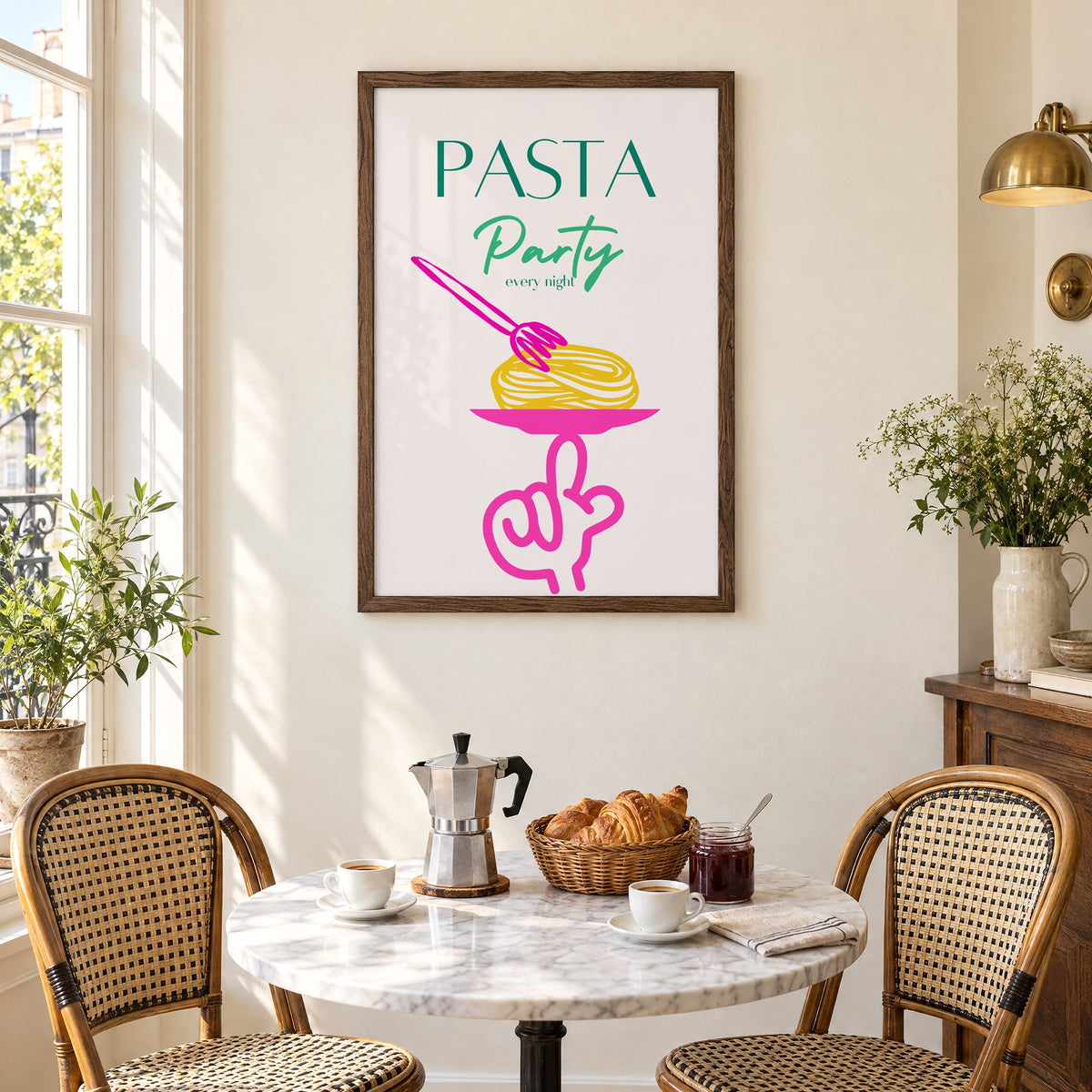 PASTA Party every night spaghetti plate print in a walnut frame above a marble bistro table with croissants and rattan chairs