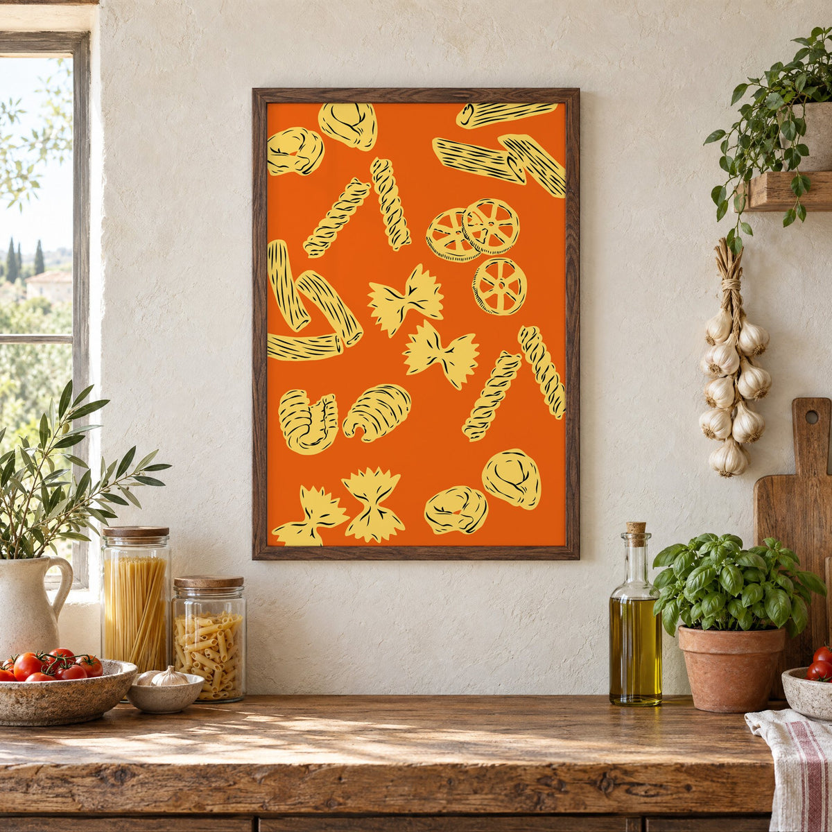 Orange pasta pattern woodcut-style print in a walnut frame above a rustic Italian pantry counter with pasta jars, garlic and tomatoes