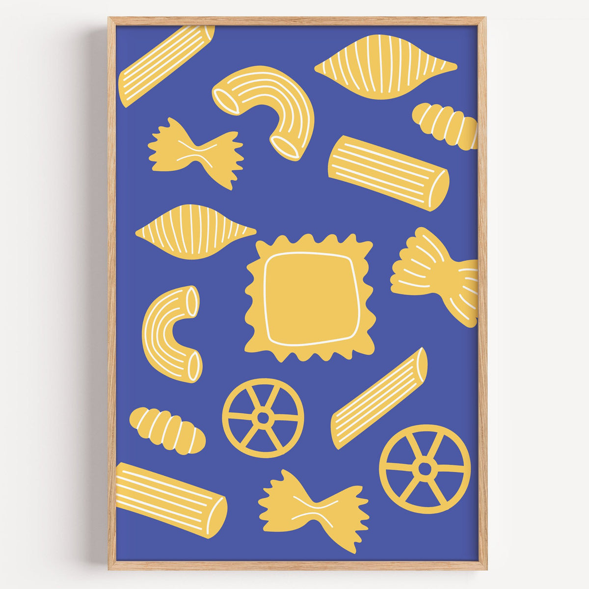 Yellow pasta shapes pattern on blue print in a light oak frame on a plain white wall