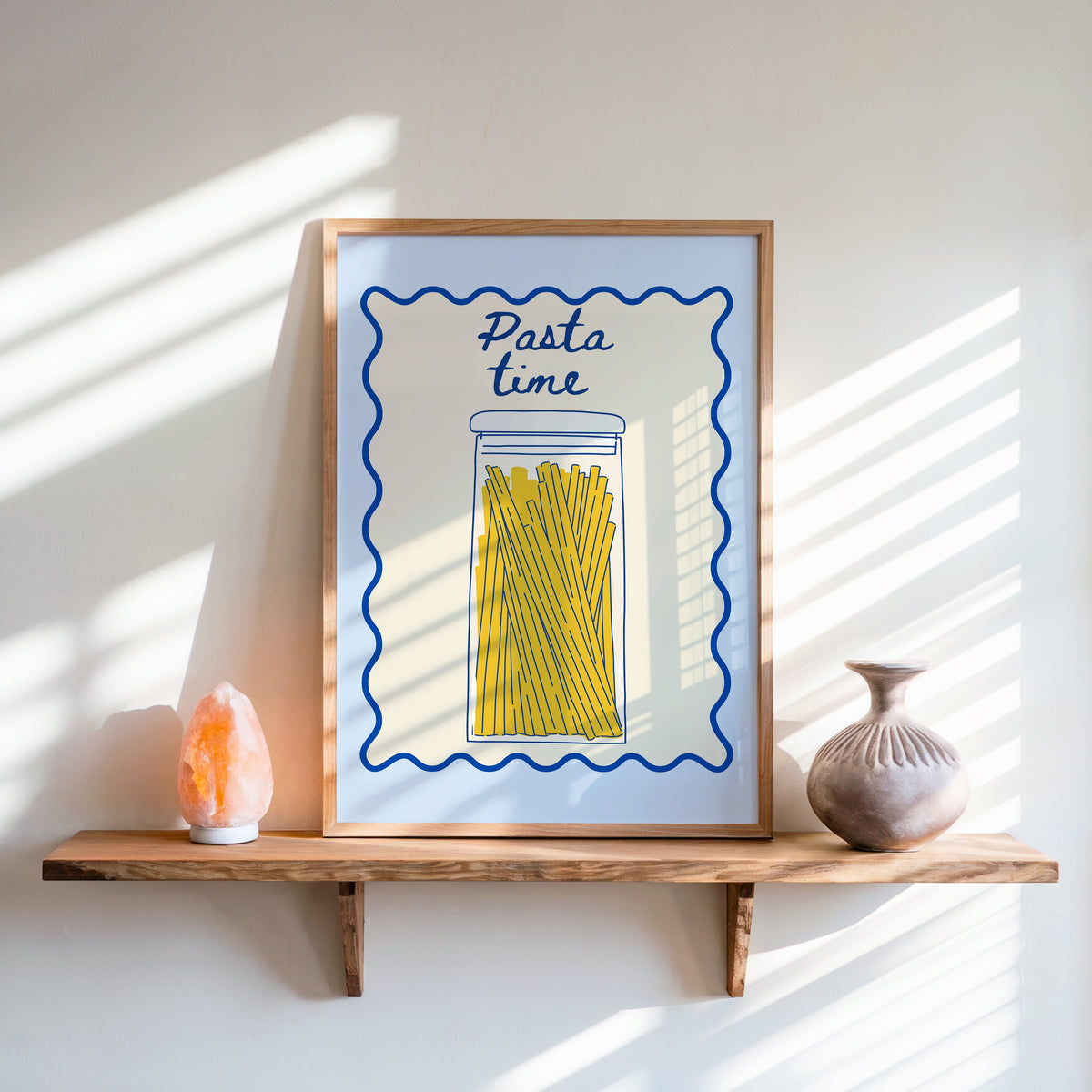 Pasta Time jar print in an oak frame on a live-edge shelf beside a salt lamp