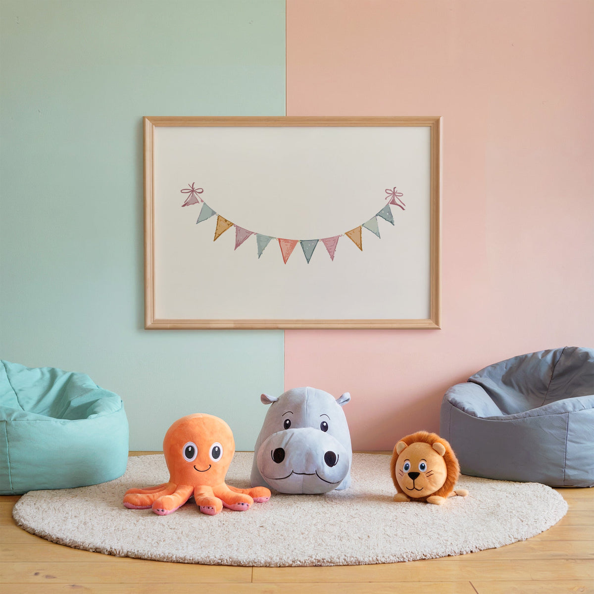 Pastel triangle bunting garland with bows nursery print in an oak frame on a mint and pink wall above plush toys