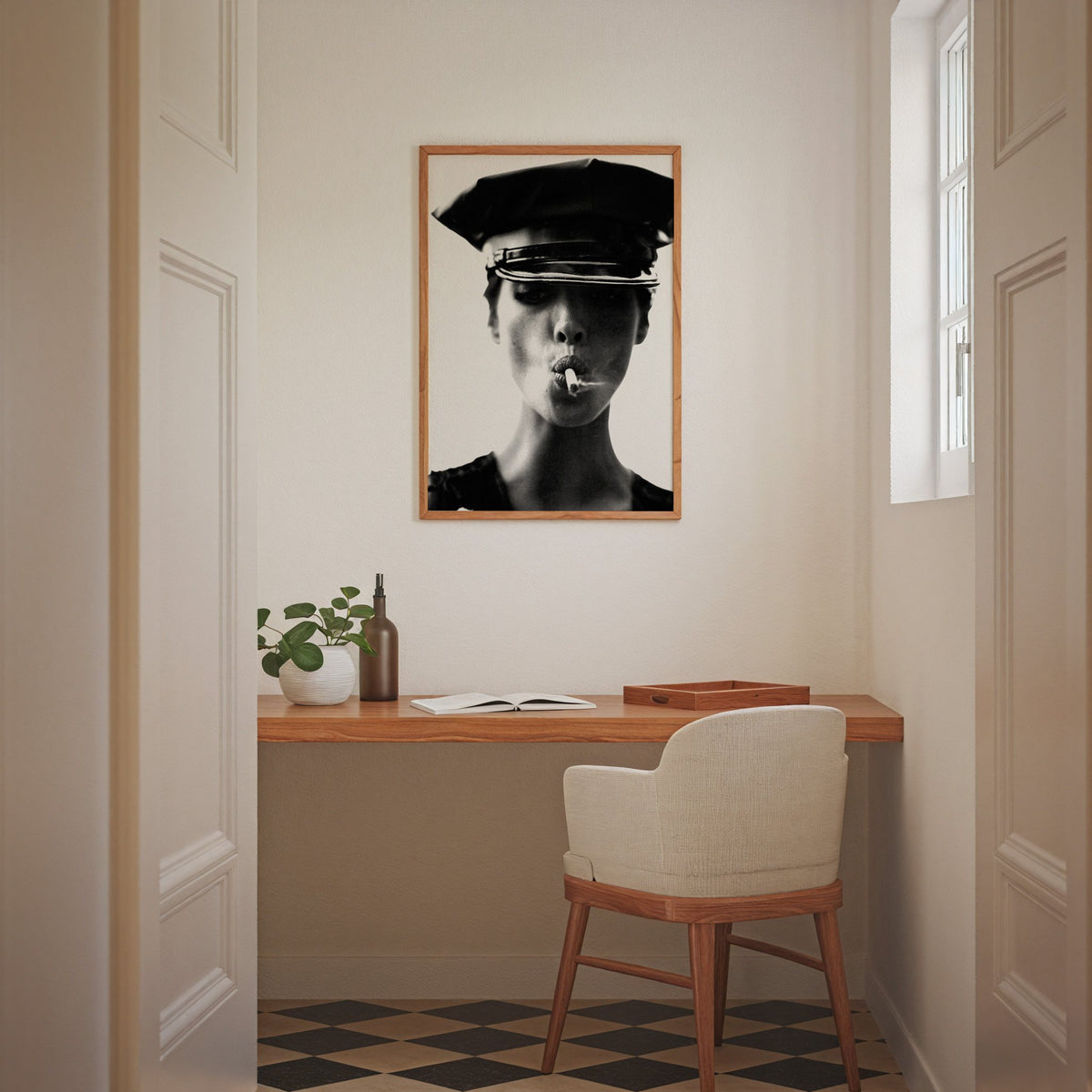 Close portrait under glossy leather cap print in an oak frame above a home office desk nook