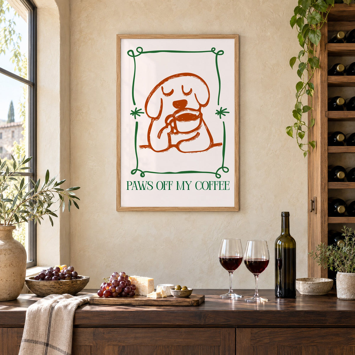PAWS OFF MY COFFEE dog and mug print in an oak frame on a limewashed wall above a wine counter with red wine, cheese and grapes