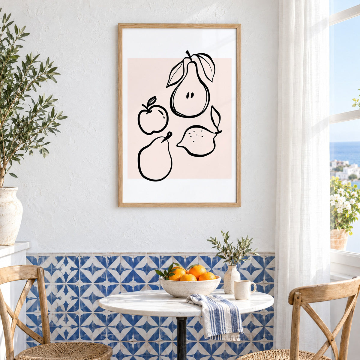 Pear apple lemon black line art print in an oak frame above a bistro table and blue patterned tiles