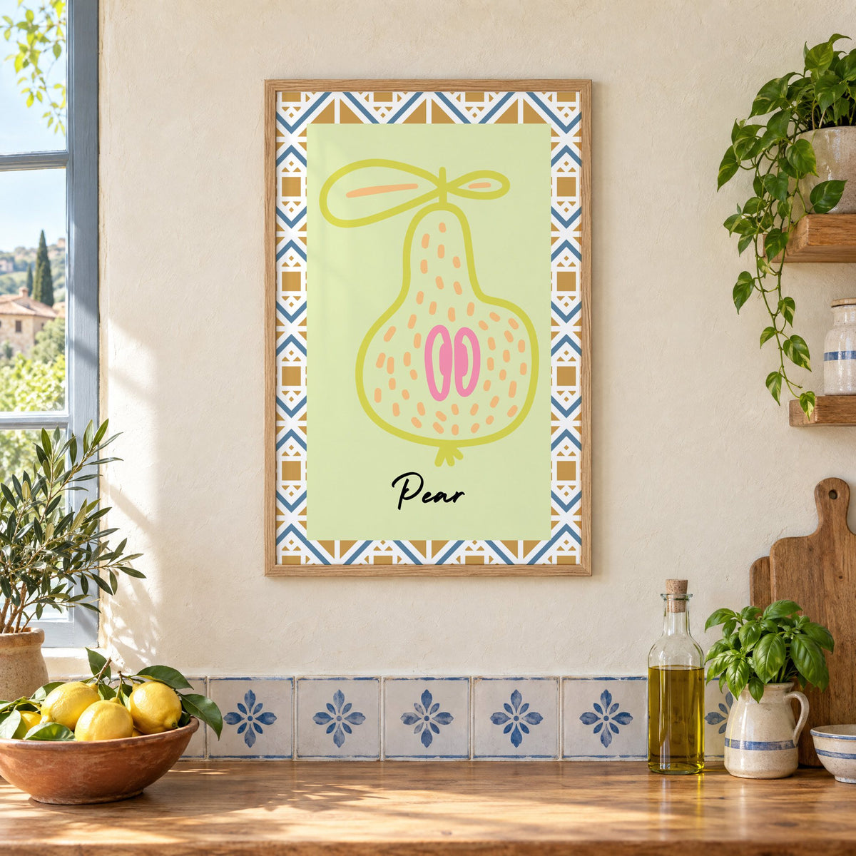 Pear lime line-art zigzag border print in an oak frame on a cream plaster wall above a worktop with a bowl of lemons and blue-and-white tiles