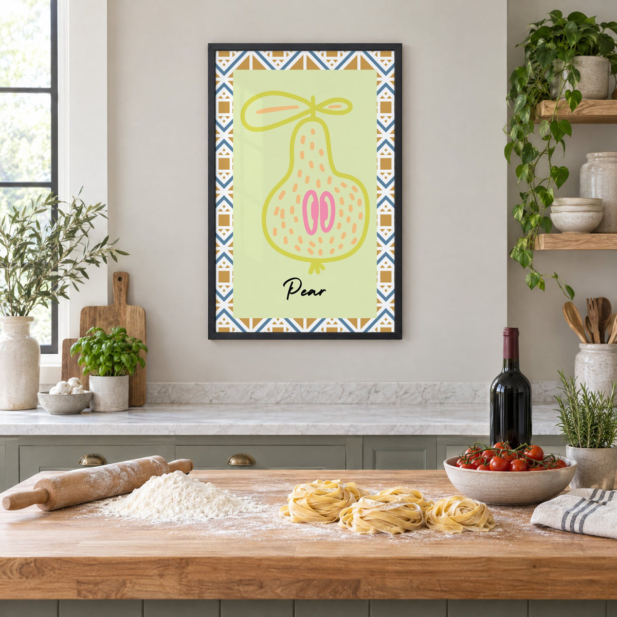 Pear lime line-art zigzag border print in a black frame above a butcher-block island with fresh pasta, flour and cherry tomatoes