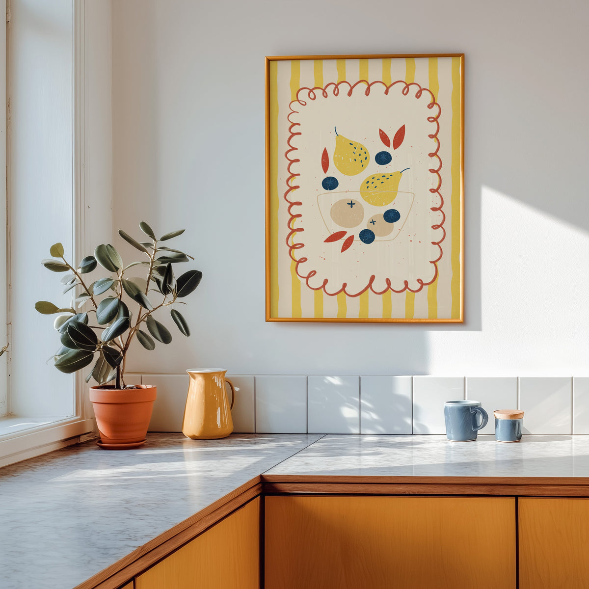 Pears and blueberries print in a gold frame above a marble counter with a yellow jug