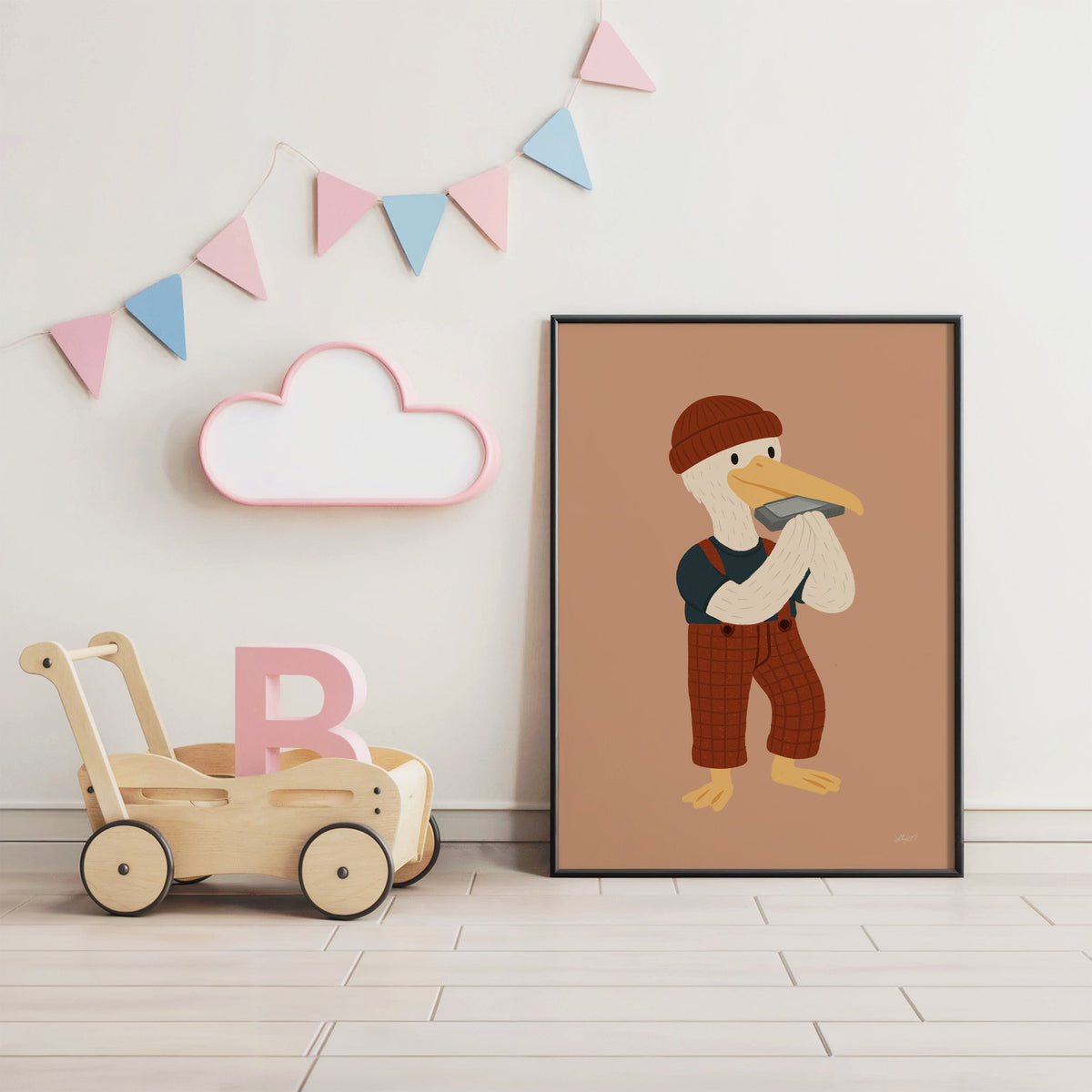 Pelican with harmonica and beanie nursery print in a black frame under pastel bunting by a wooden baby walker