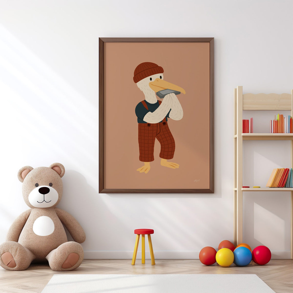 Pelican with harmonica and beanie nursery print in a walnut frame above a big teddy bear by a bookshelf