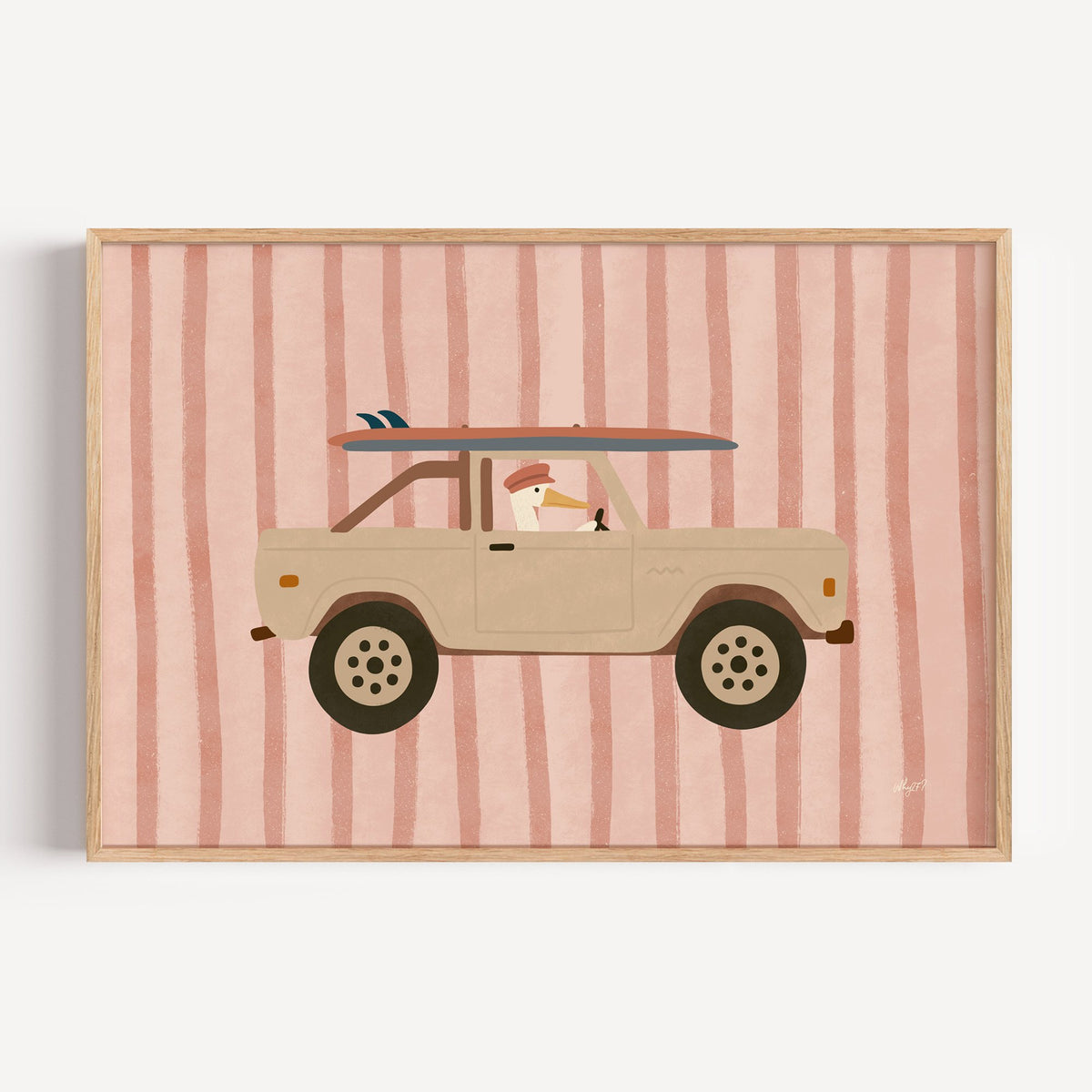 Pelican driving beige truck pink nursery print in a light oak frame on a plain white wall