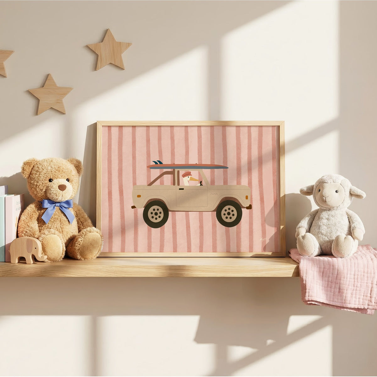 Pelican driving beige truck pink nursery print in an oak frame on a wall shelf between a teddy bear and a toy lamb