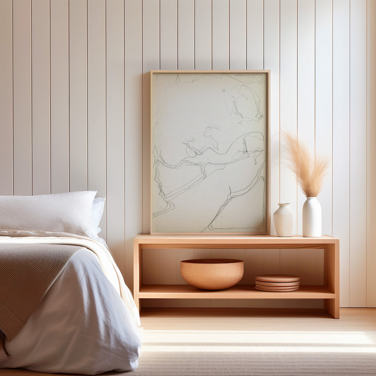 Pencil contour sketch of an abstract profile print in a light oak frame on a wood bench by a bed with pampas grass