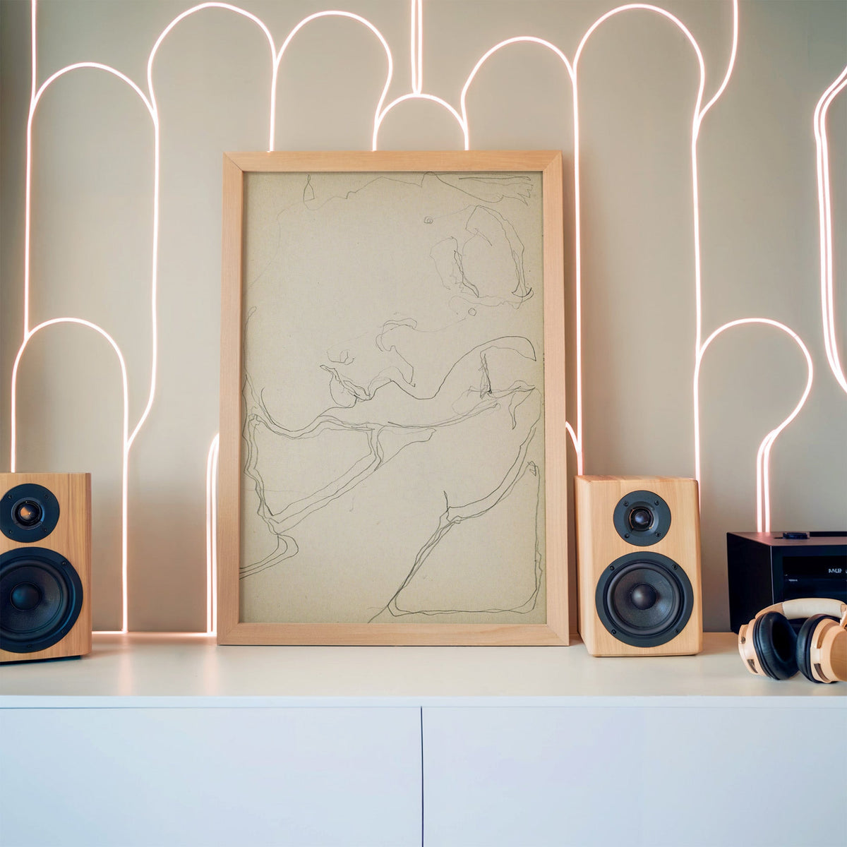 Pencil contour sketch of an abstract profile print in a pine frame between wooden speakers by a neon arch light wall
