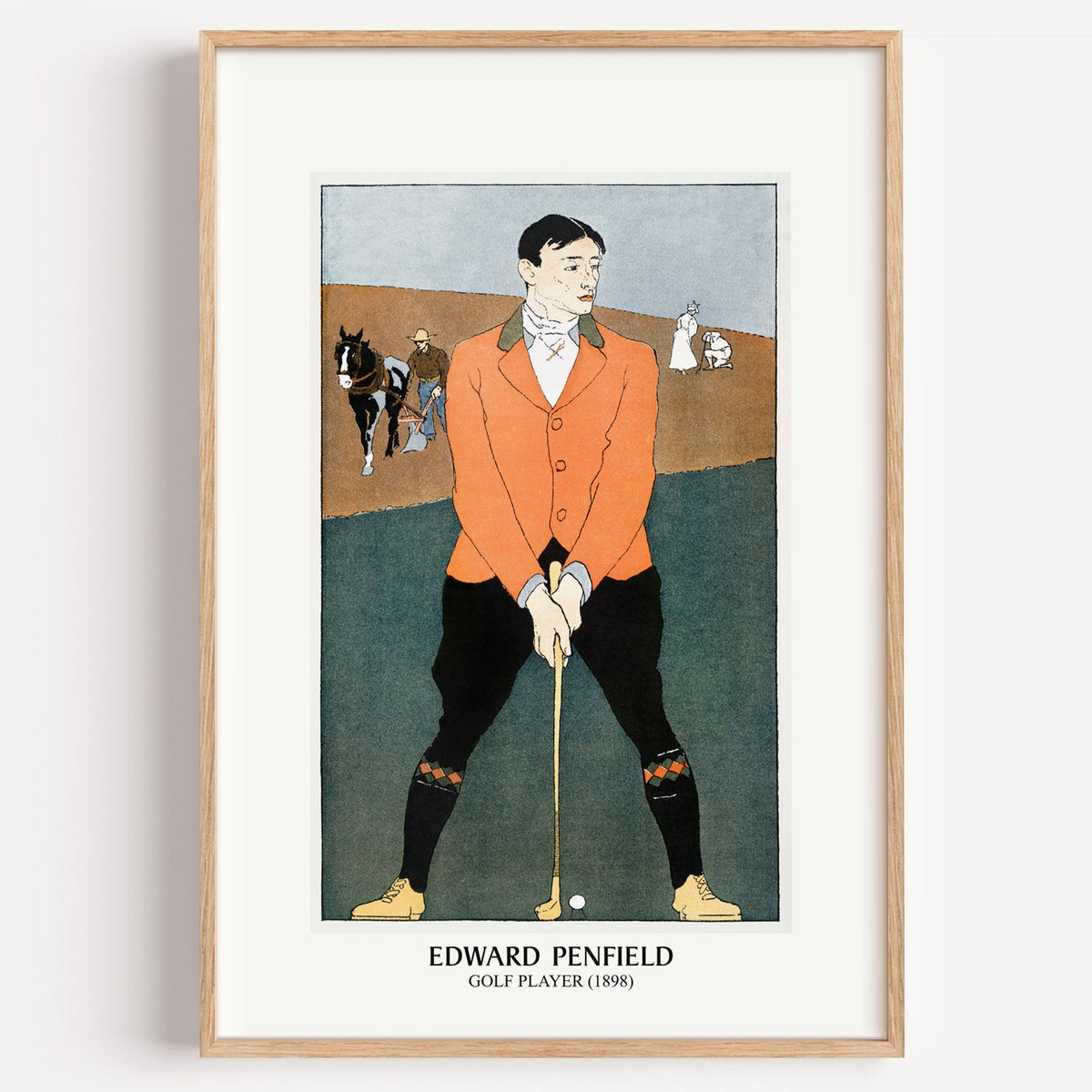 Edward Penfield Golf Player print in a light oak frame on a plain white wall