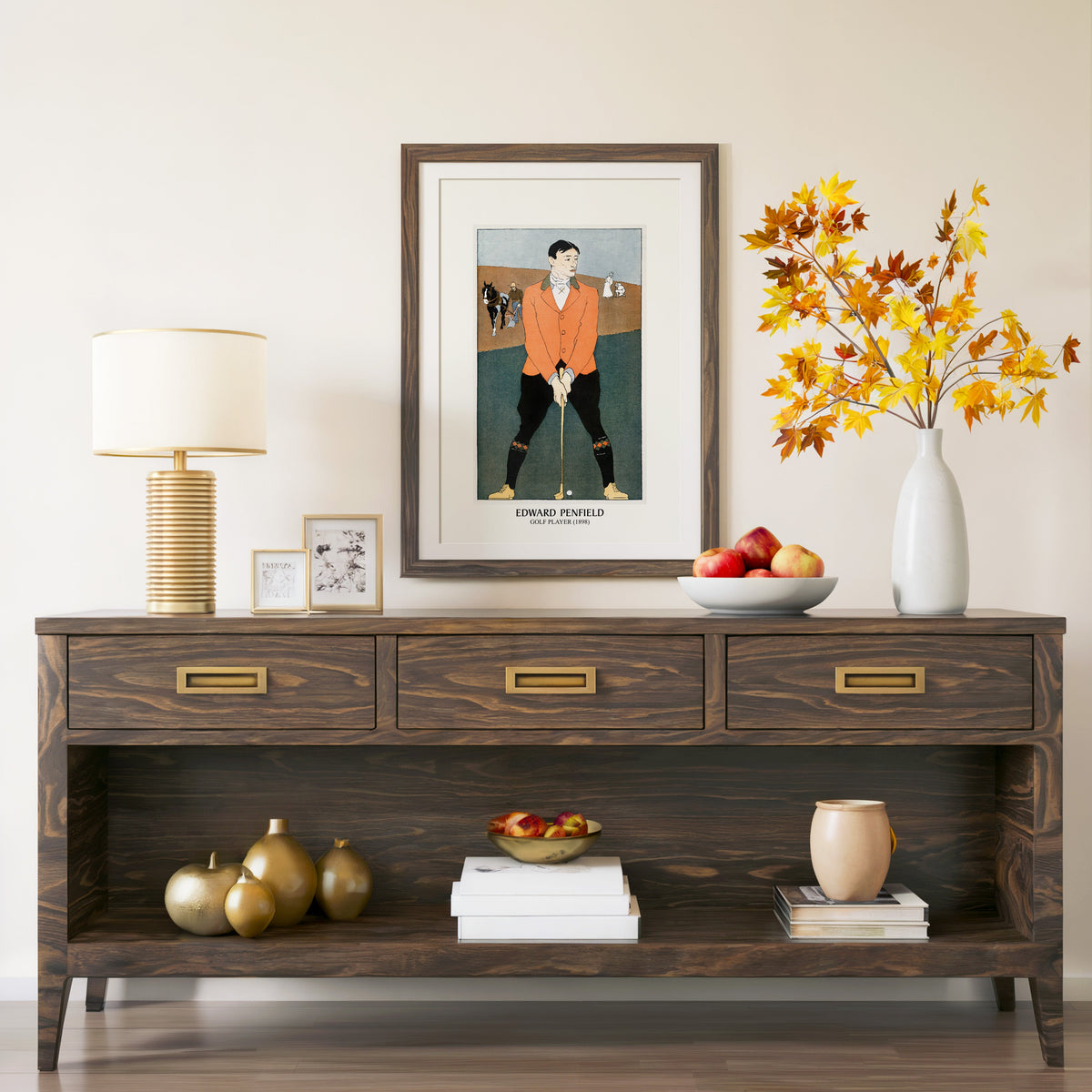 Golf Player print in a walnut frame above a console with autumn branches