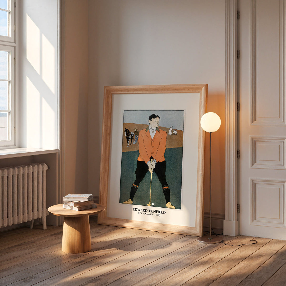 Penfield golf poster in a wide pine frame leaning by a sunlit window