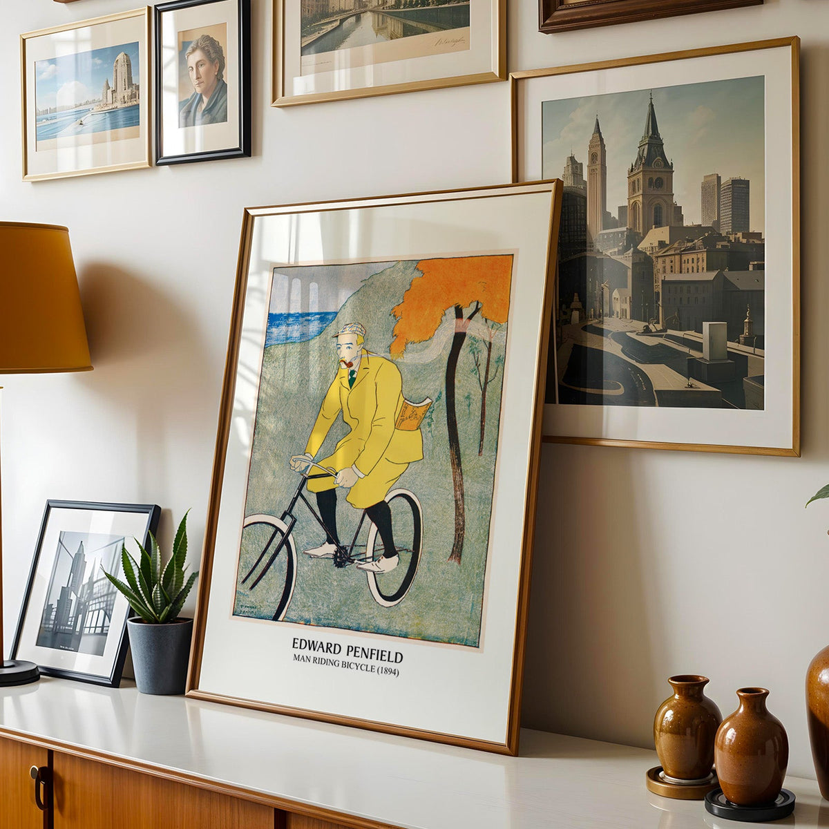 Penfield cycling poster shown in a gold frame leaning on a sideboard