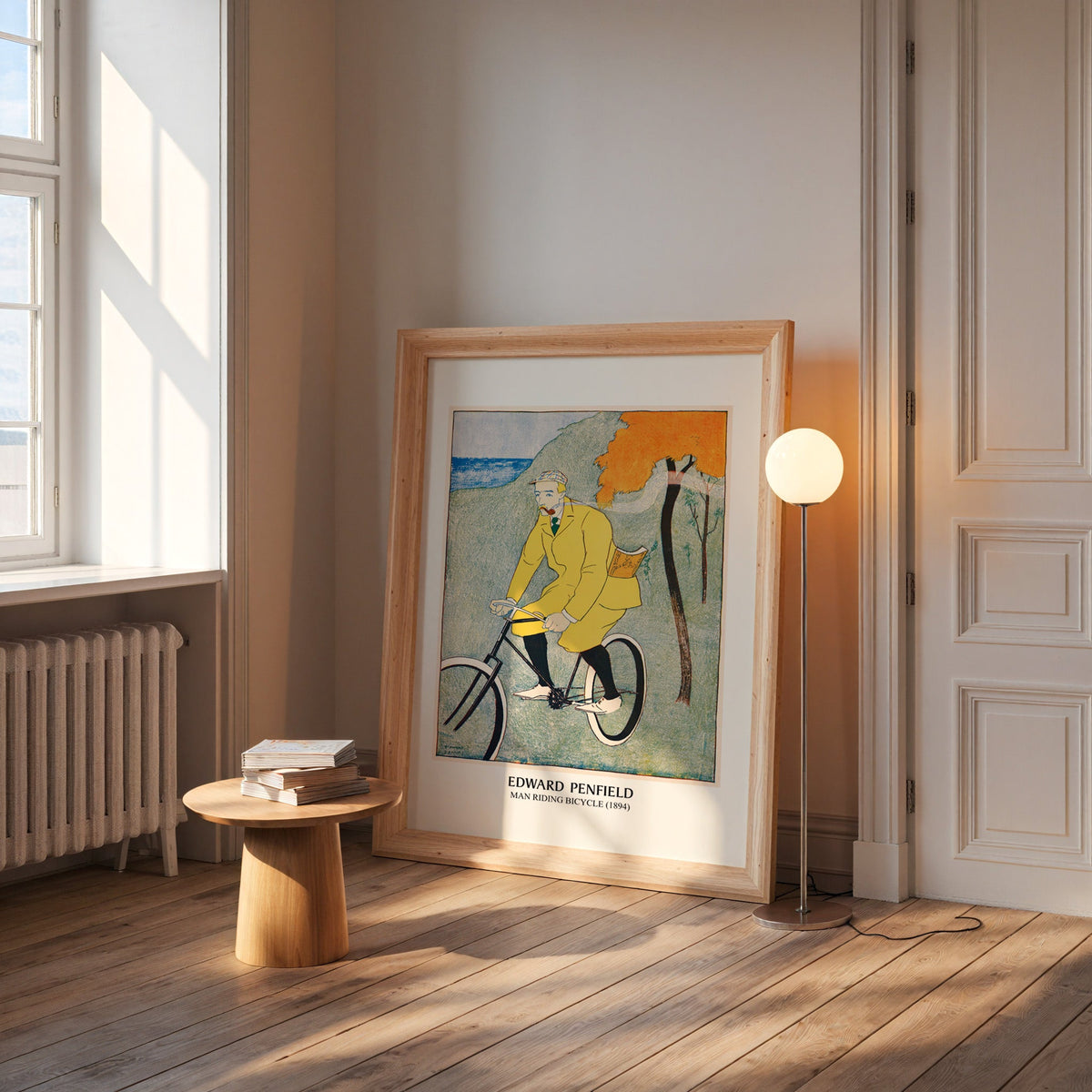 Penfield bicycle poster in a wide pine frame leaning by a sunlit window