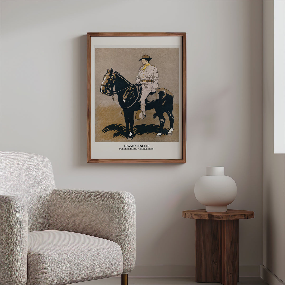 Penfield horse poster in a slim walnut frame above a bouclé armchair