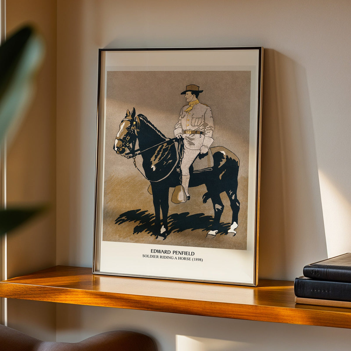 Soldier on horse print in a black frame on a walnut shelf in warm evening light