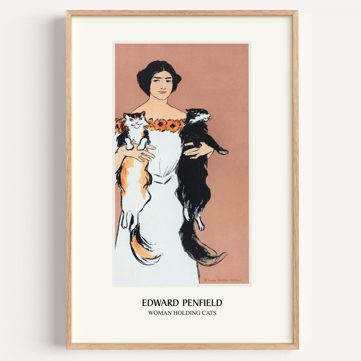 Edward Penfield Woman Holding Cats print in a light oak frame on a white wall