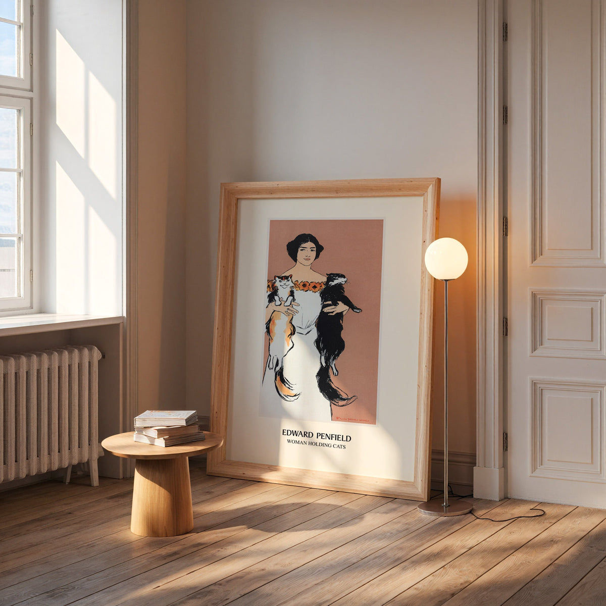 Vintage cat poster in a wide pine frame leaning by a sunlit window