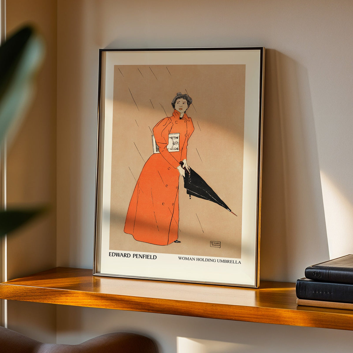 Woman Holding Umbrella print in a black frame on a walnut shelf in evening light