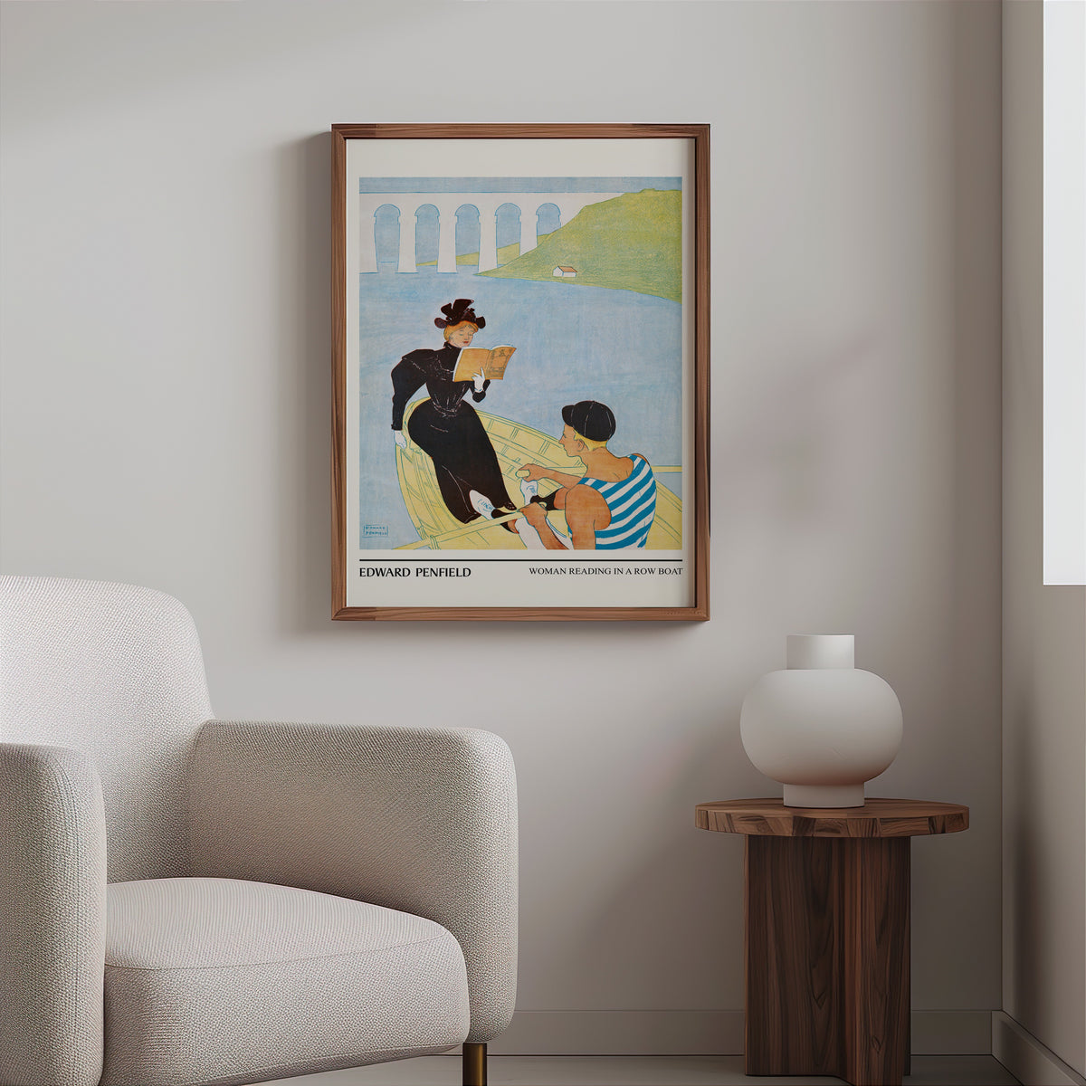 Vintage boating poster in a slim walnut frame above a bouclé armchair