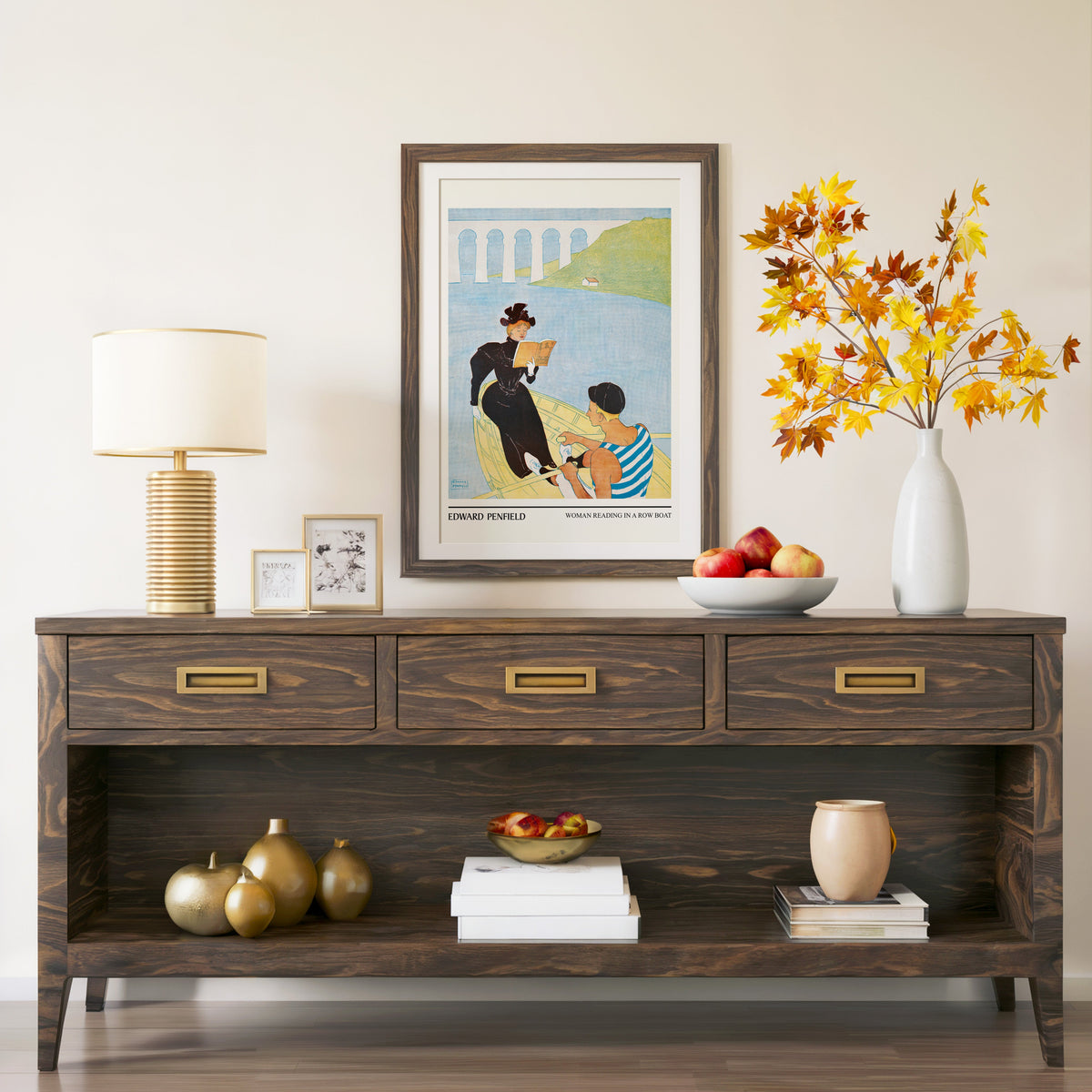 Woman Reading in a Row Boat print in a walnut frame above a console