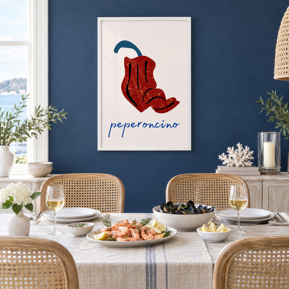 peperoncino red chili grunge print in a white frame on a navy wall above a dining table set with shrimp and mussels