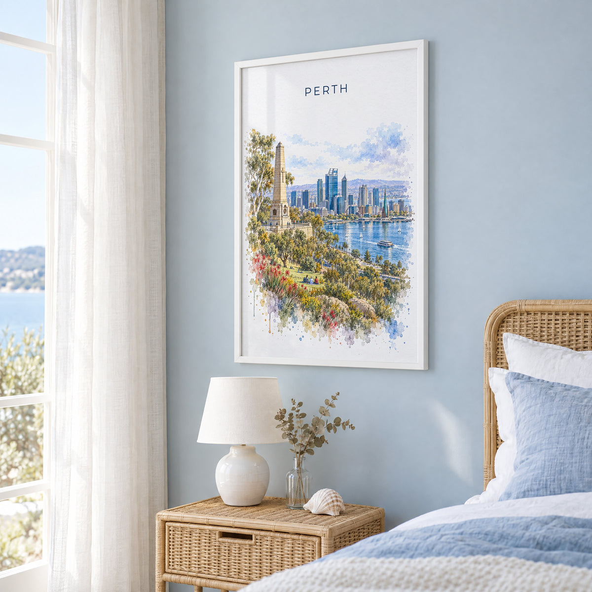 Perth, Australia watercolor print in a white frame on a pale blue wall beside a rattan bed in a coastal bedroom