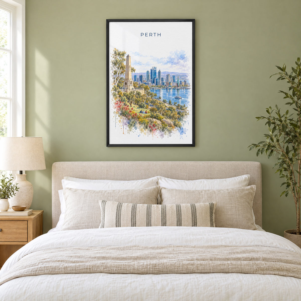Perth, Australia watercolor print in a black frame above an upholstered headboard in a sage green bedroom