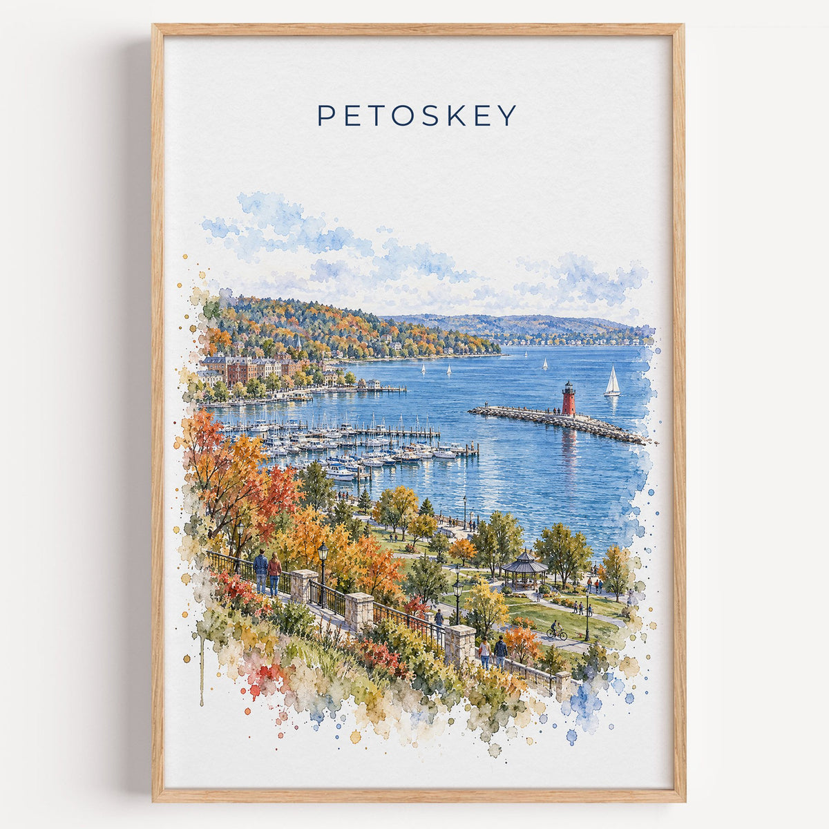 Petoskey watercolor print in a light oak frame on a plain white wall