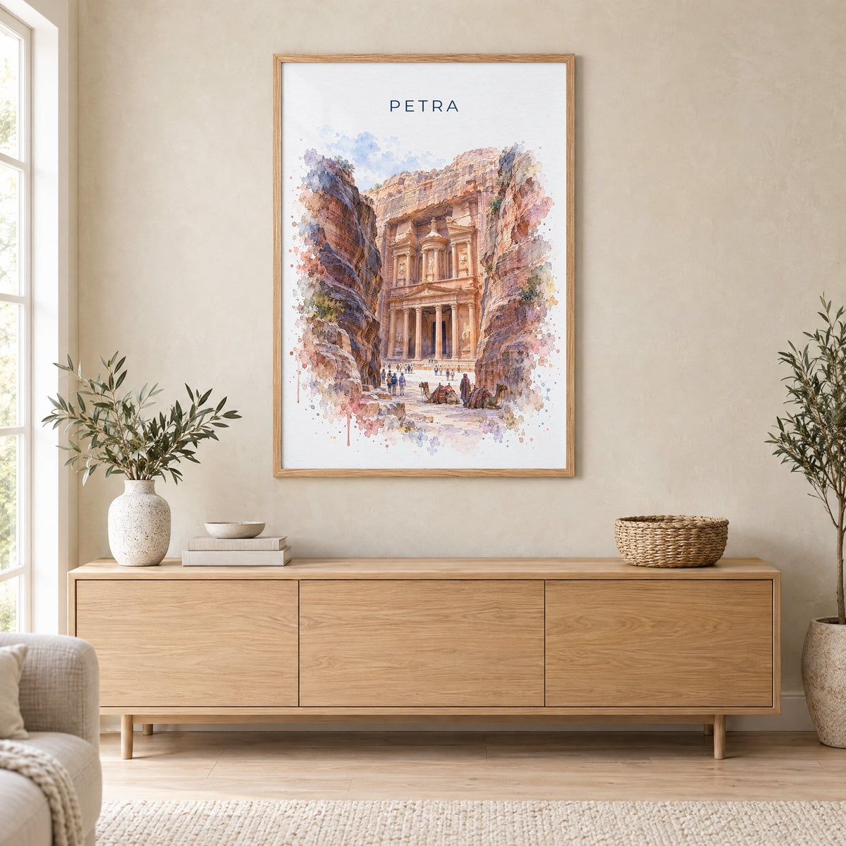 Petra watercolor print in an oak frame above a light wood sideboard in a Scandinavian living room