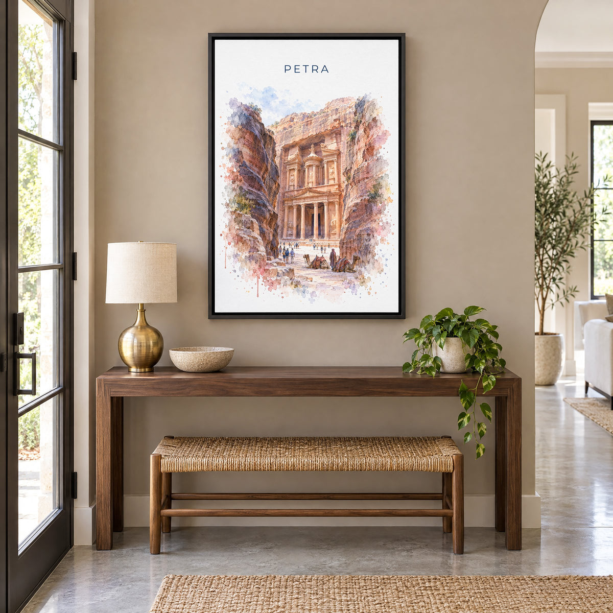 Petra watercolor print as a black floater canvas above a walnut console and woven bench in an entryway