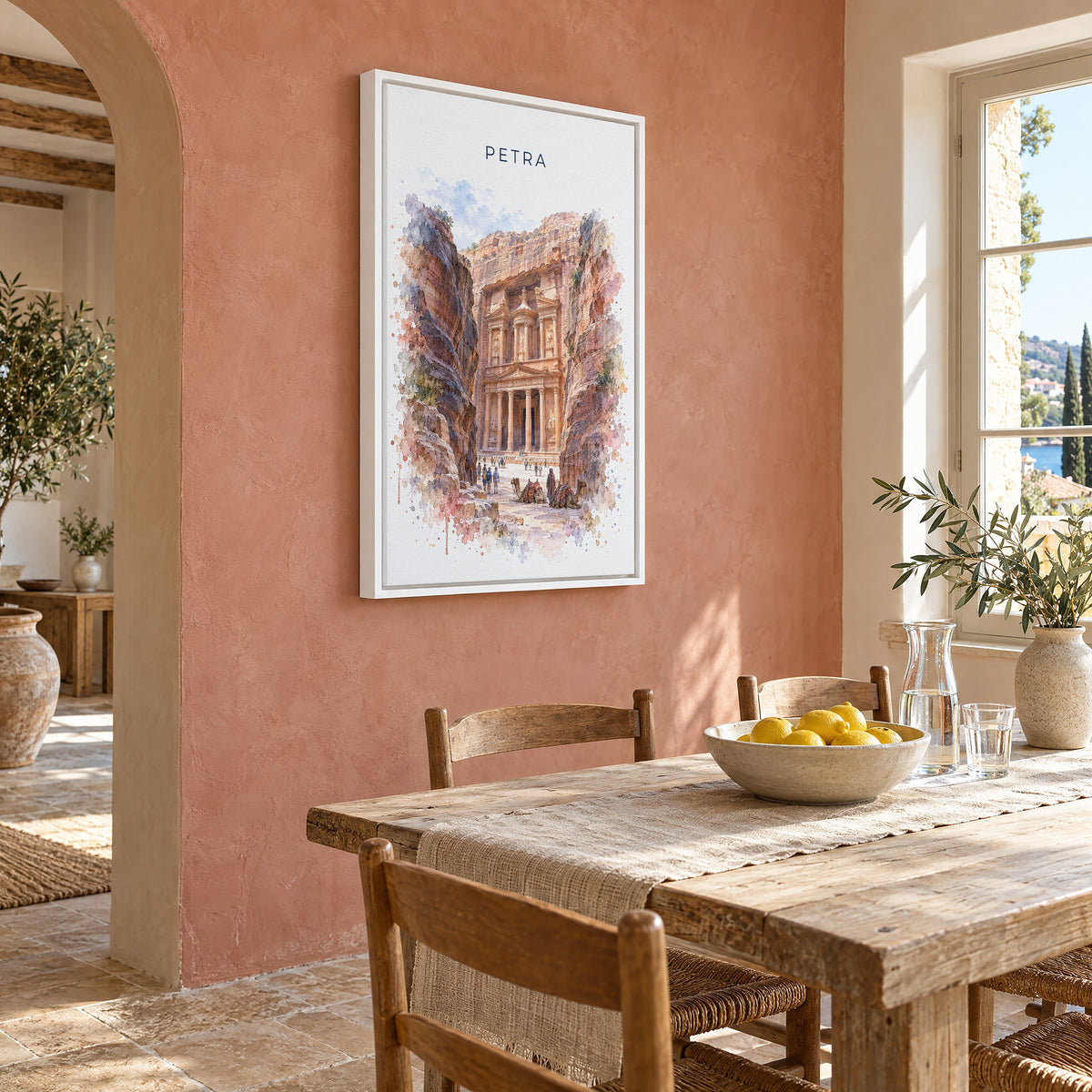 Petra watercolor print as a white floater canvas on a terracotta wall above a rustic dining table