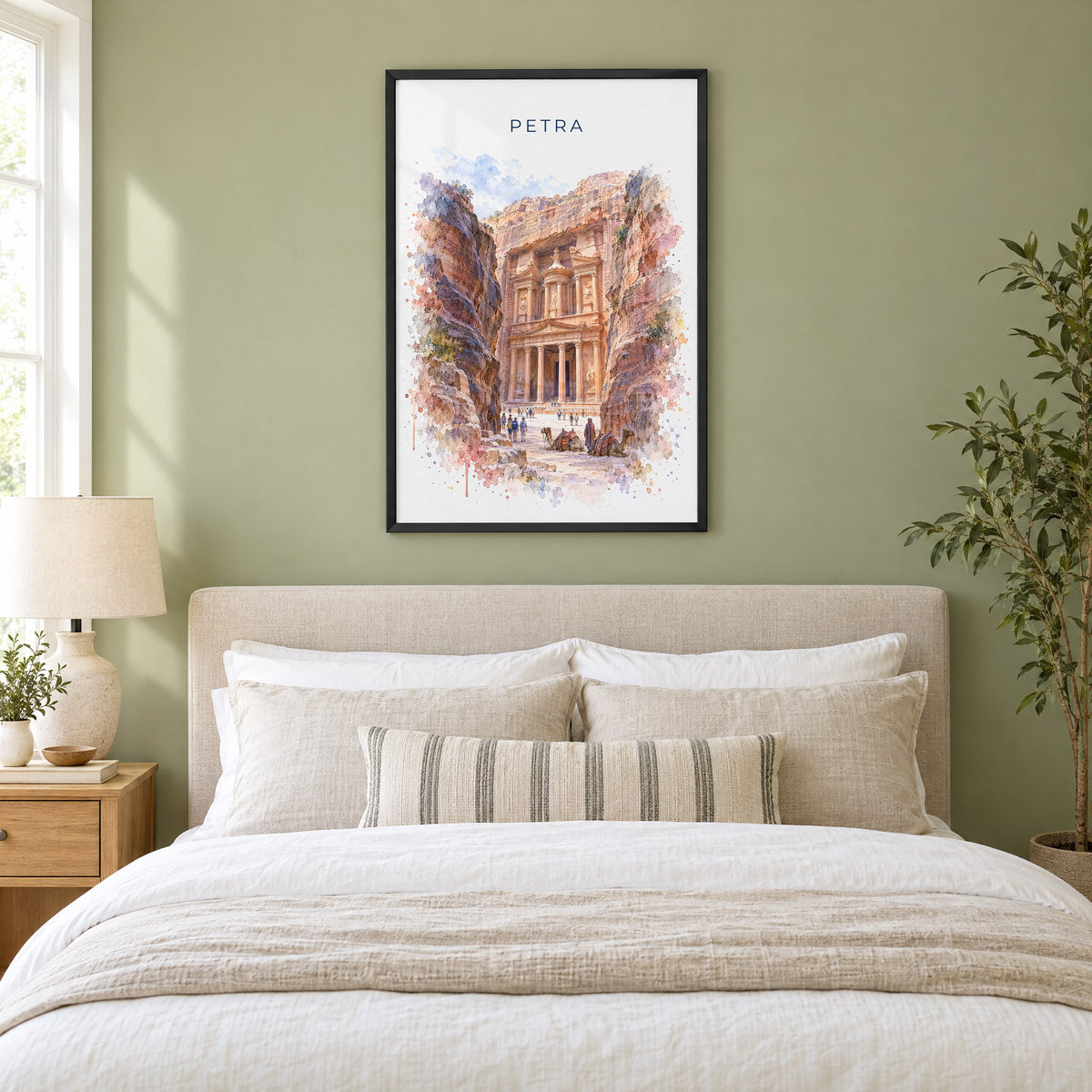 Petra watercolor print in a black frame above an upholstered headboard in a sage green bedroom