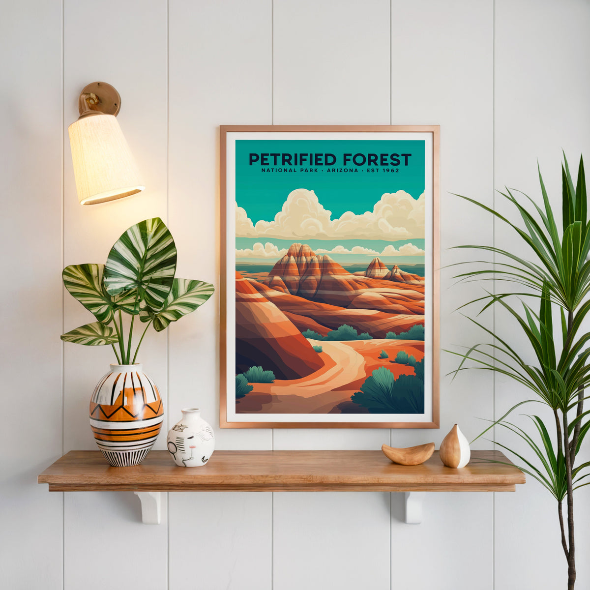 Petrified Forest National Park print in a copper frame above an oak shelf on shiplap with a brass sconce