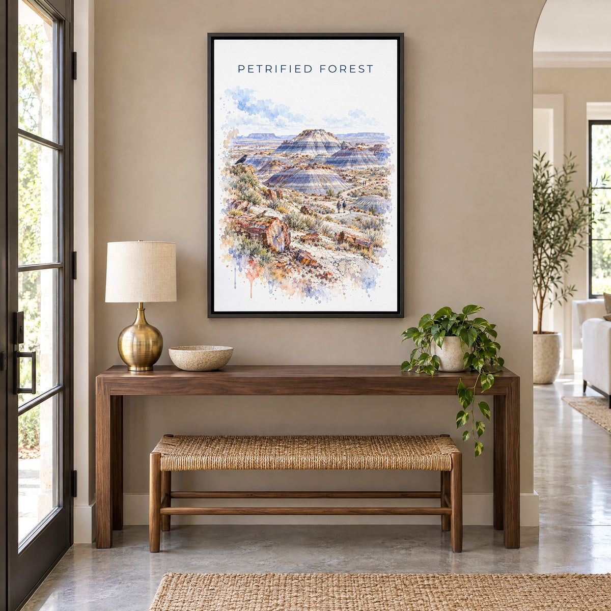 Petrified Forest National Park watercolor as a black floater canvas above a walnut console and woven bench in an entryway