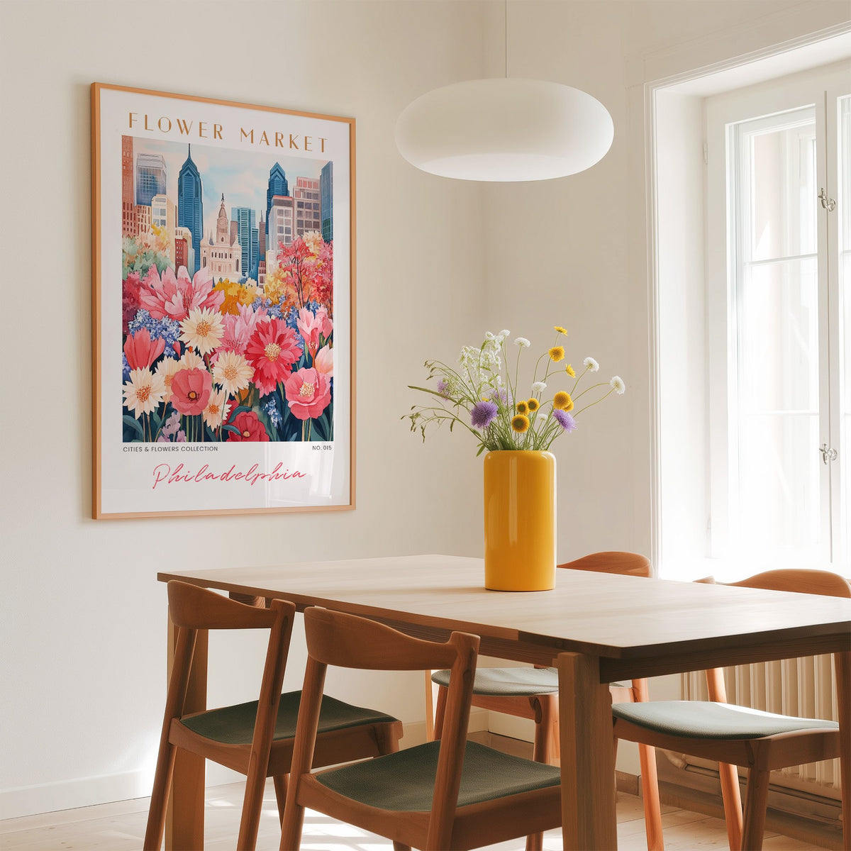 Philadelphia flower market print in an oak frame above a dining table with a yellow vase and white pendant light