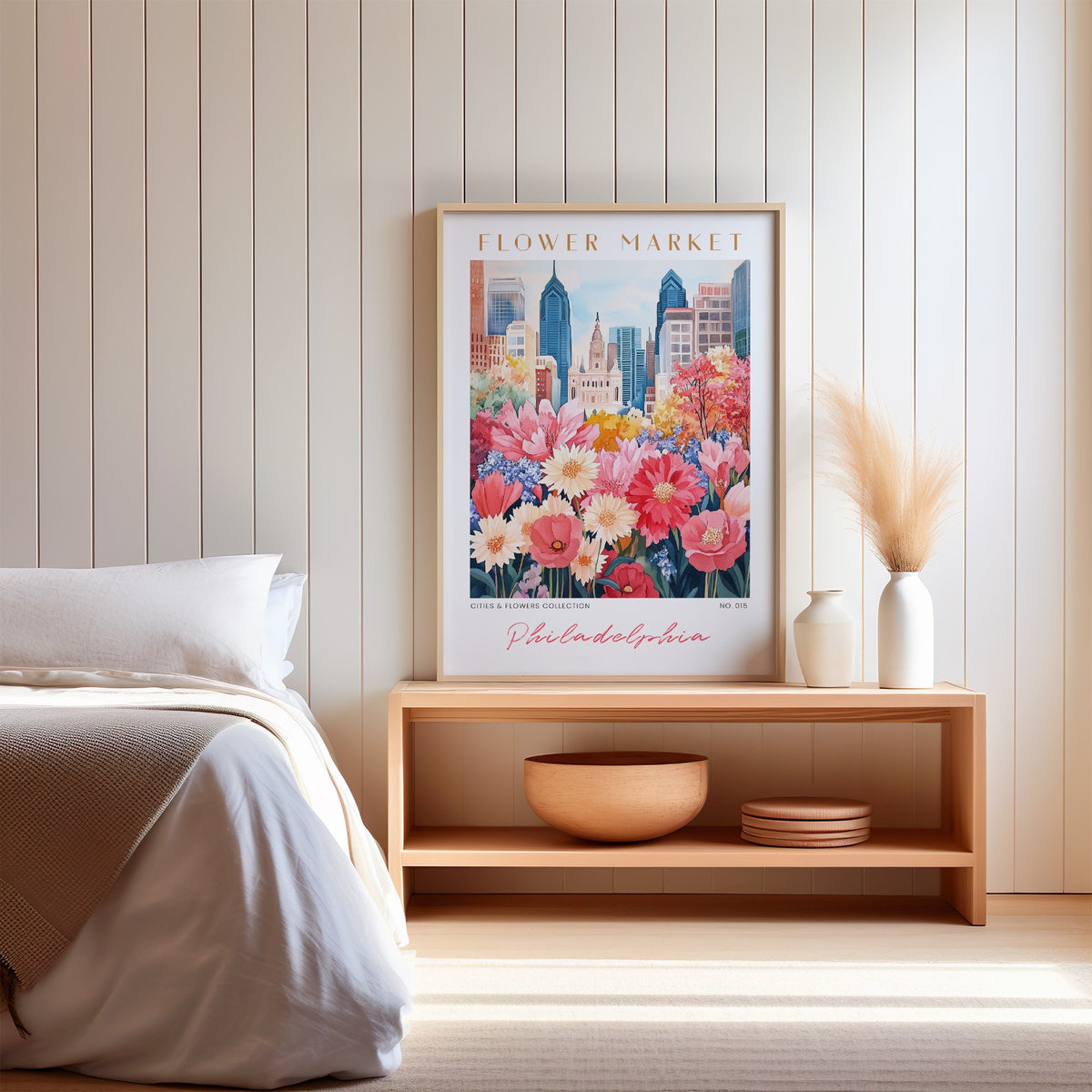 Philadelphia flower market print in an oak frame on a wood bench against a white shiplap bedroom wall with pampas grass